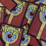 Photo showing the backs of scattered MetaZoo cards.