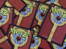 Photo showing the backs of scattered MetaZoo cards.